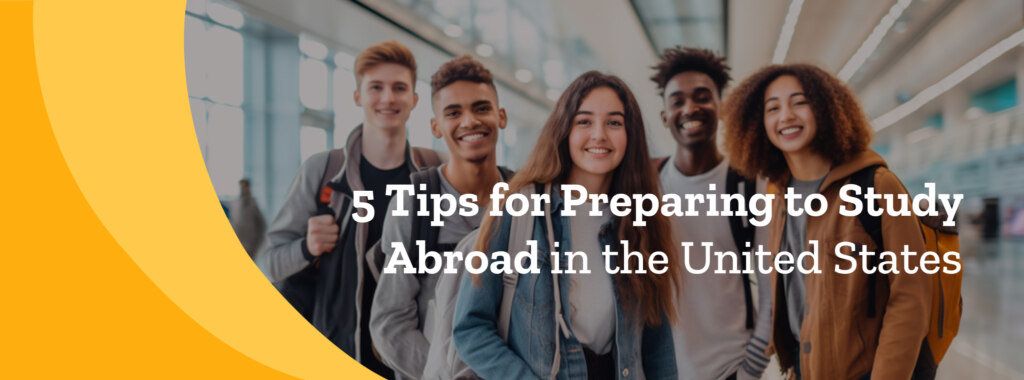 Five young college students wearing backpacks smile and look at the camera.