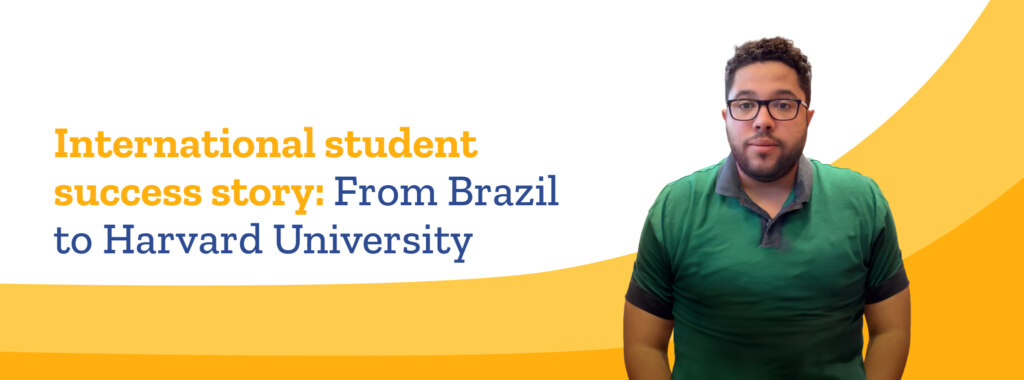 Brazilian international student Michael Cerqueira smiles, wearing glasses and a green, short-sleeved shirt.