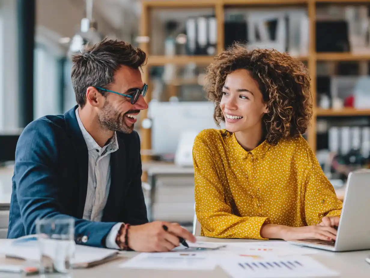 Insert Image alt text hereGraduate and advisor discussing loan repayment graph in a modern office