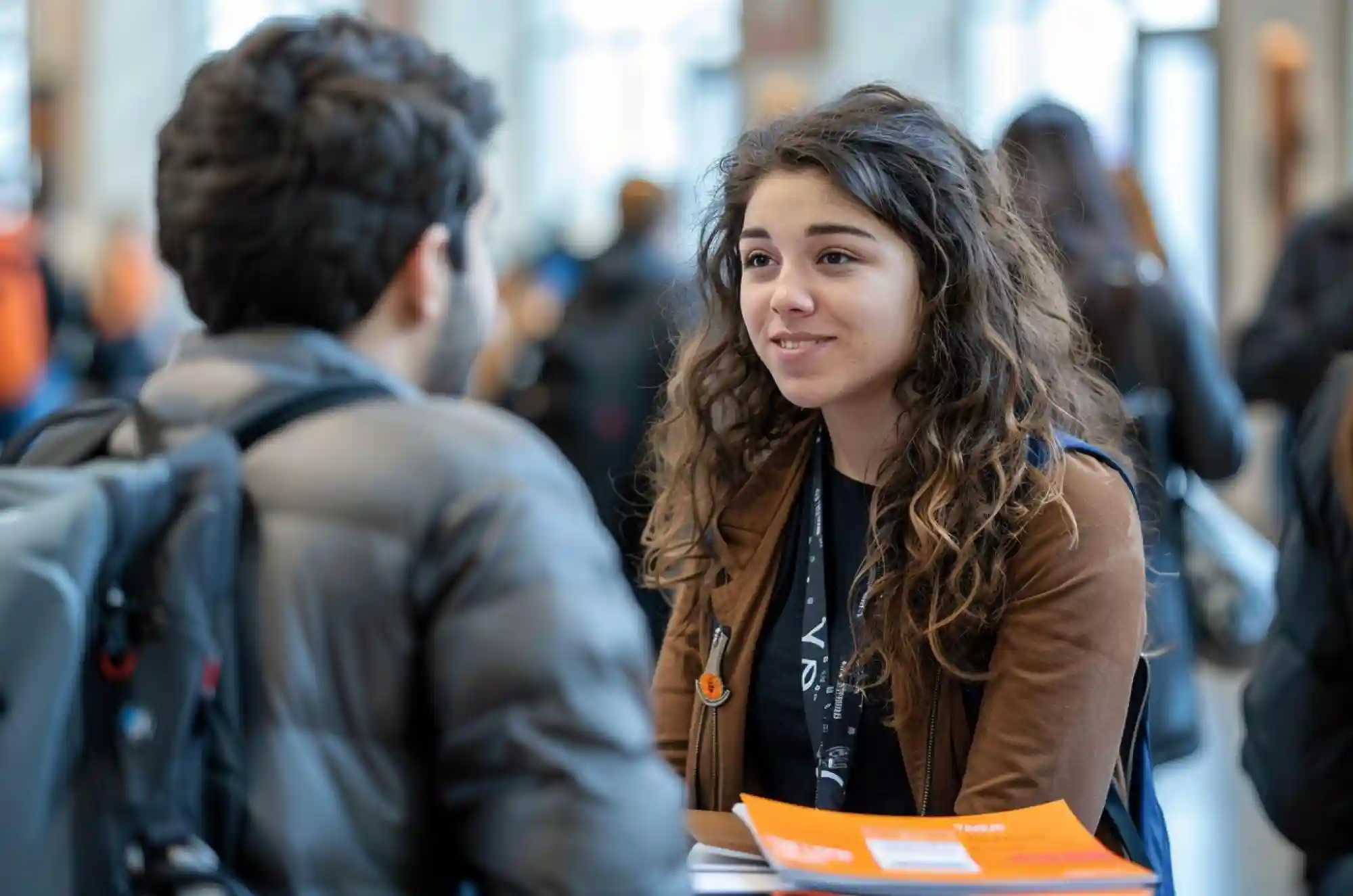 International student at a career fair, speaking to a recruiter.