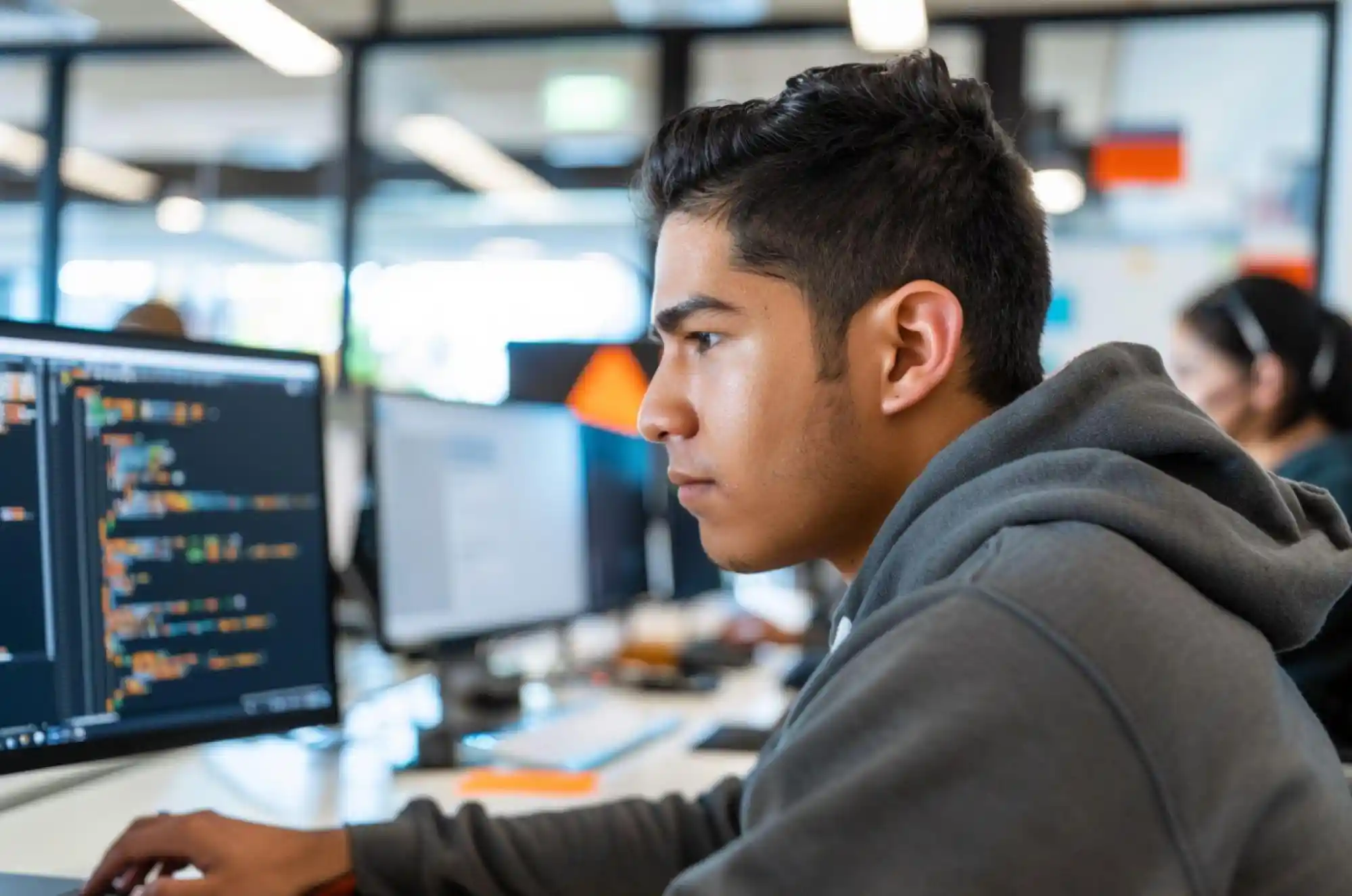 International student working on codes on his PC, in a lab setup.